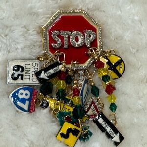 LUNCH AT THE RITZ broach with driving motif. RARE! Lots of charms.